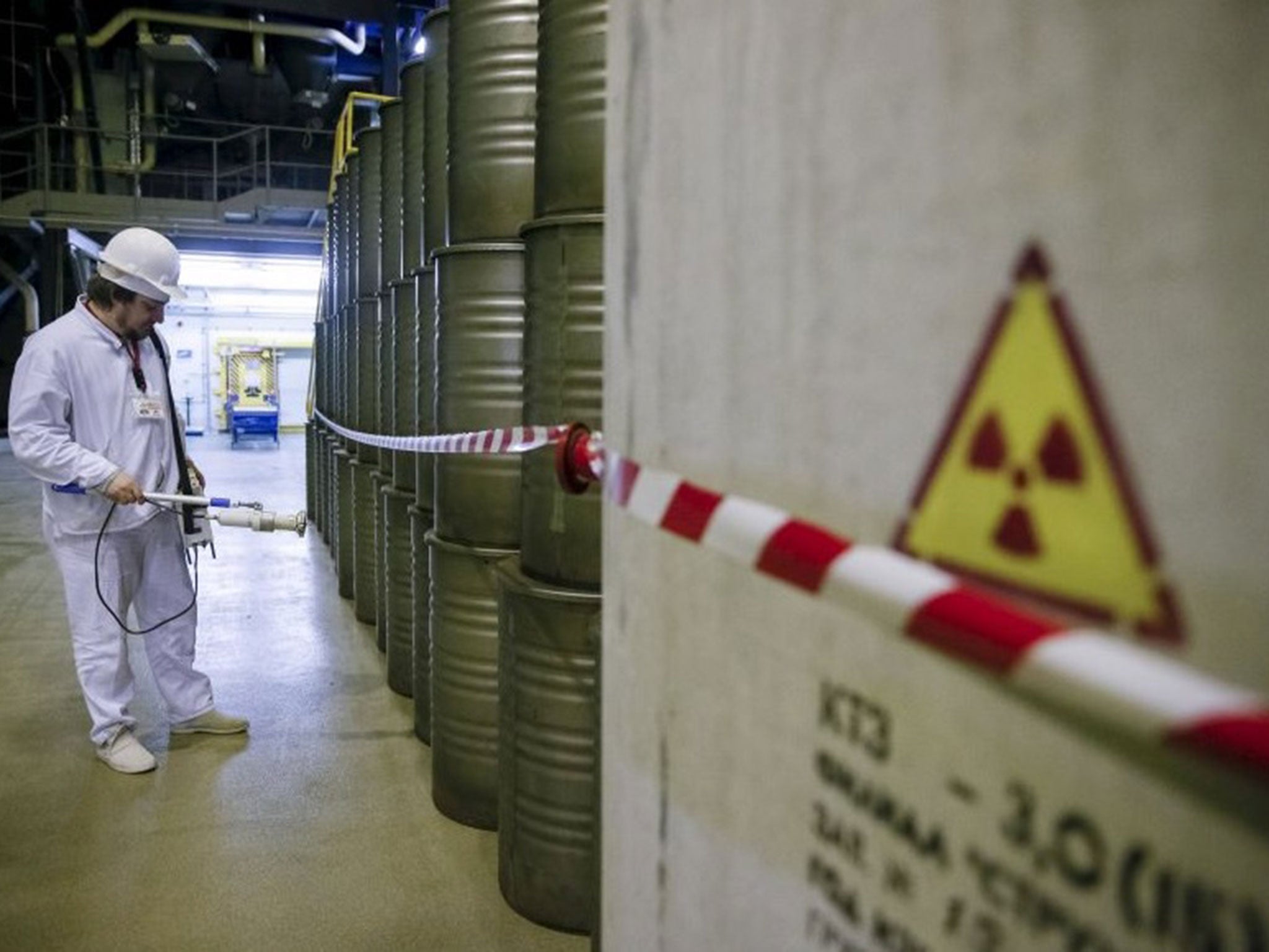 An employee measures the radiation level at a plant for processing liquid radioactive waste at the Chernobyl nuclear power plant