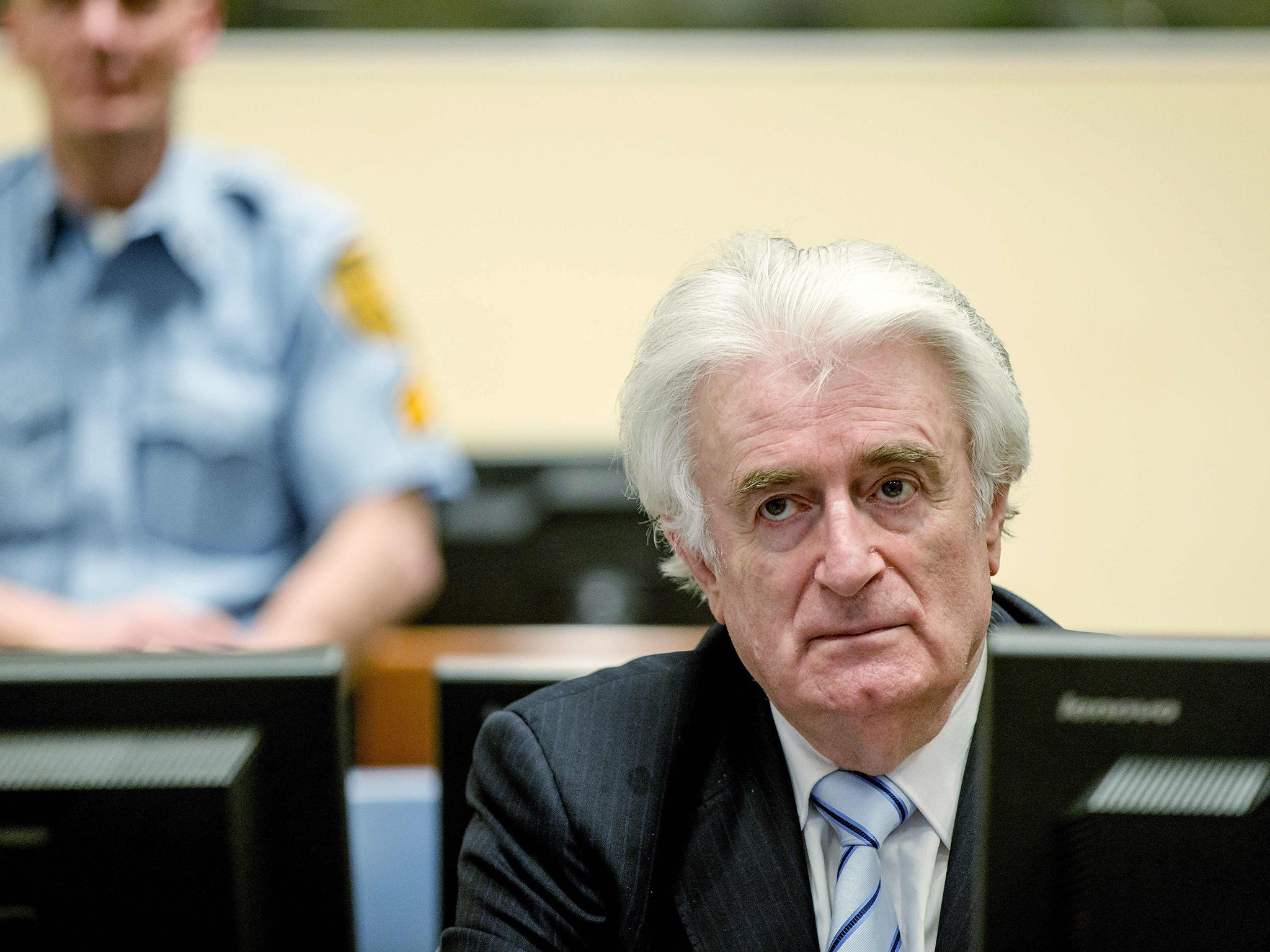 Bosnian Serb wartime leader Radovan Karadzic sits in the courtroom for the reading of his verdict at the International Criminal Tribunal for Former Yugoslavia