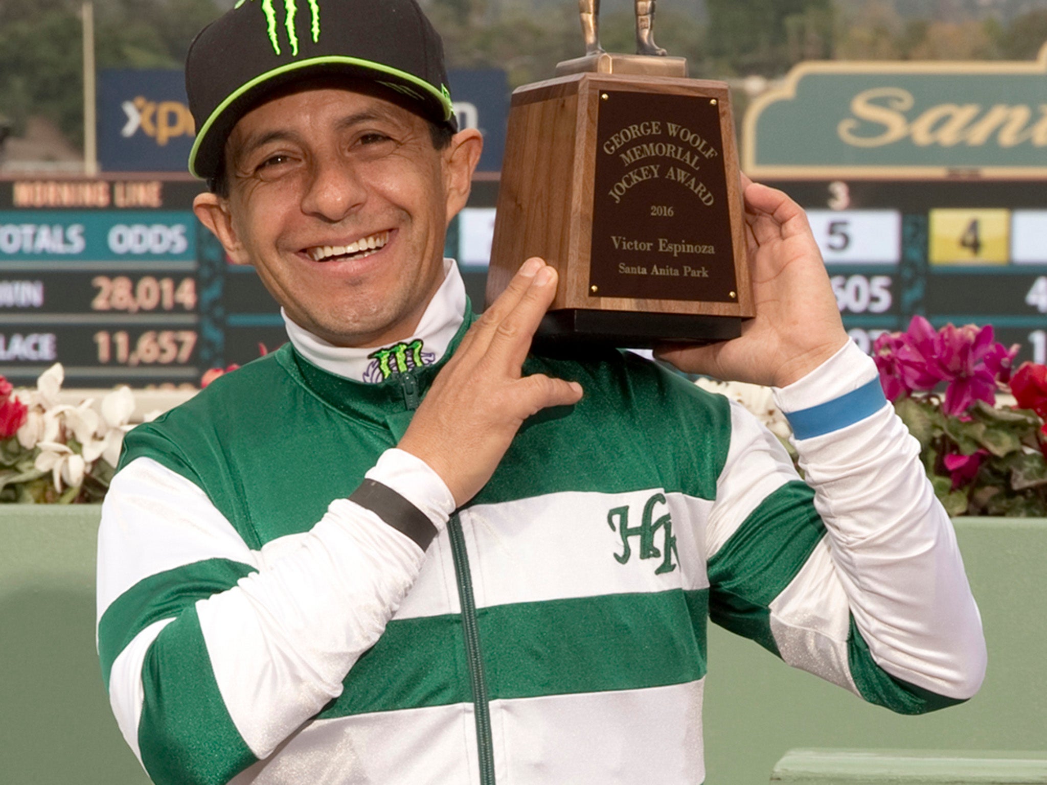 Triple Crown champion jockey Victor Espinoza, a 43-year-old native of Mexico City, poses for a photo with his trophy he received in a winnerís circle ceremony at Santa Anita Park, Arcadia, Calif.