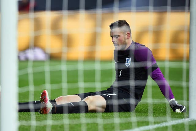 Jack Butland appears dejected after sustaining an ankle injury against Germany
