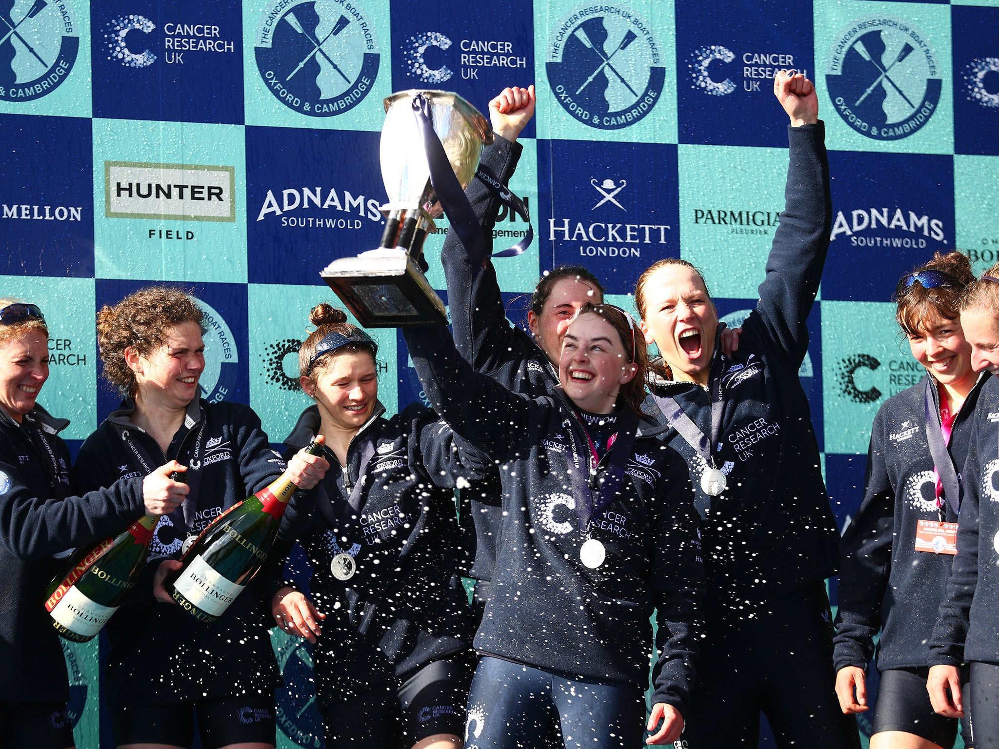 The Oxford crew celebrate with the trophy following their victory during The Cancer Research UK Women's Boat Race