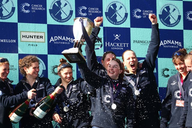 The Oxford crew celebrate with the trophy following their victory during The Cancer Research UK Women's Boat Race