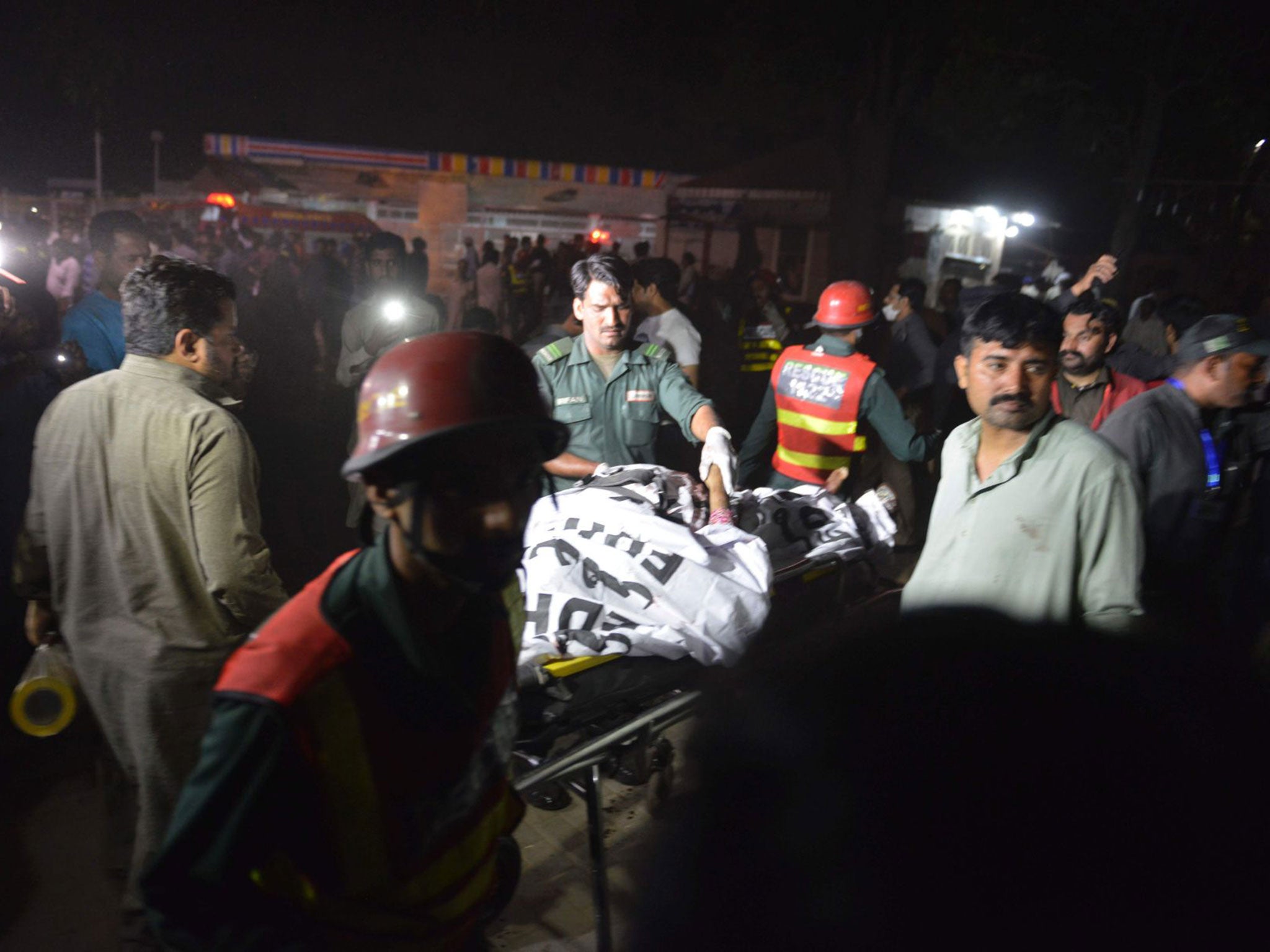 Emergency services tending to victims at the park following the explosion in Lahore