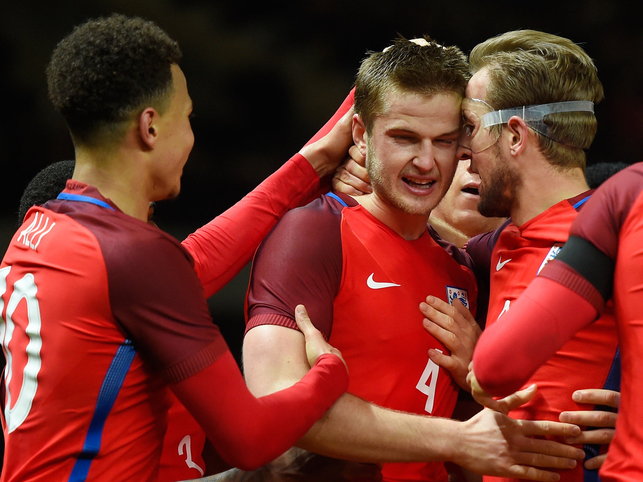 Dele Alli and Harry Kane congratulate club and international team-mate Eric Dier