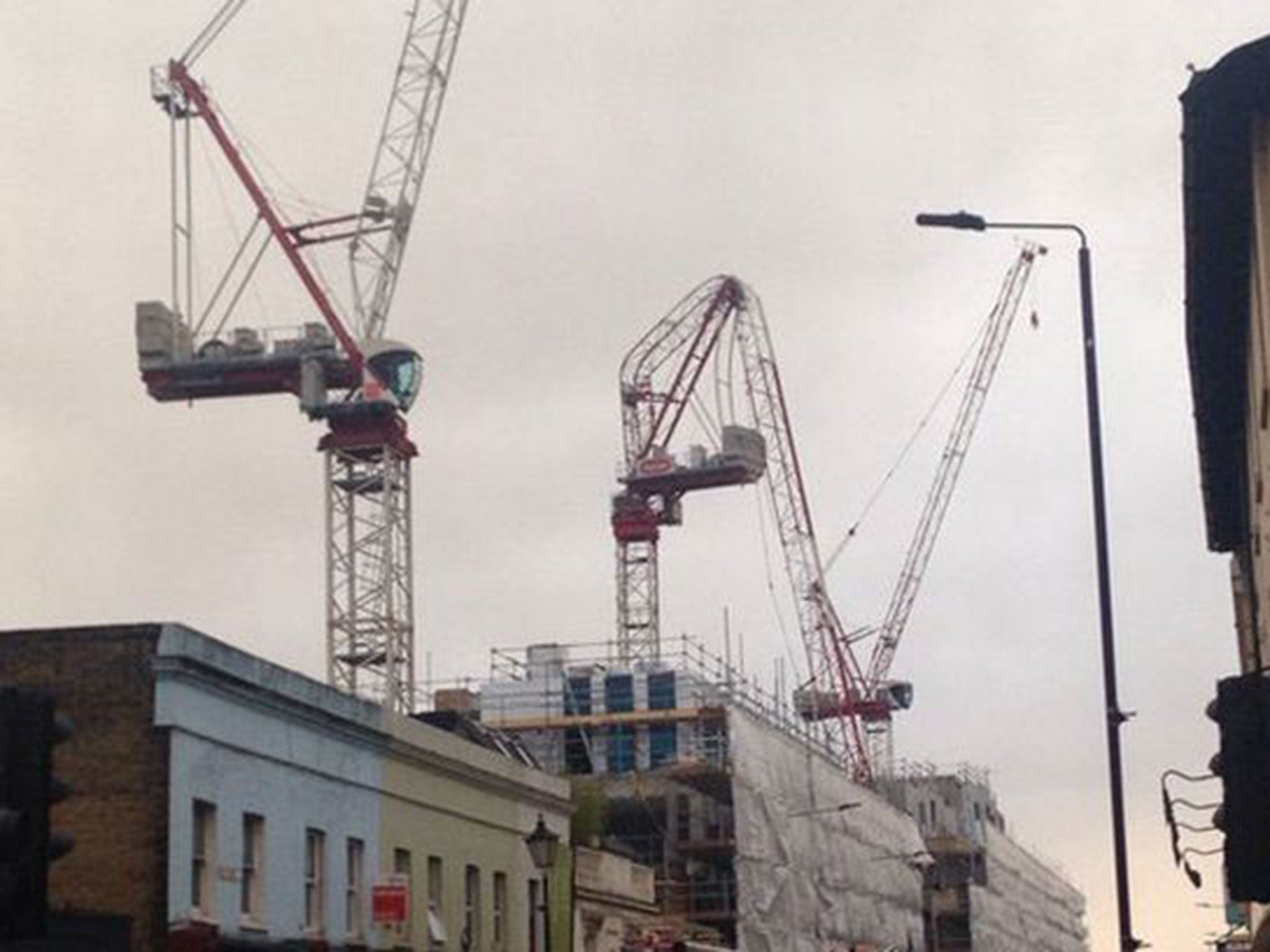 Emergency services have evacuated the area where a crane was folded almost on itself by winds (Twitter/Gavin Rolfe )