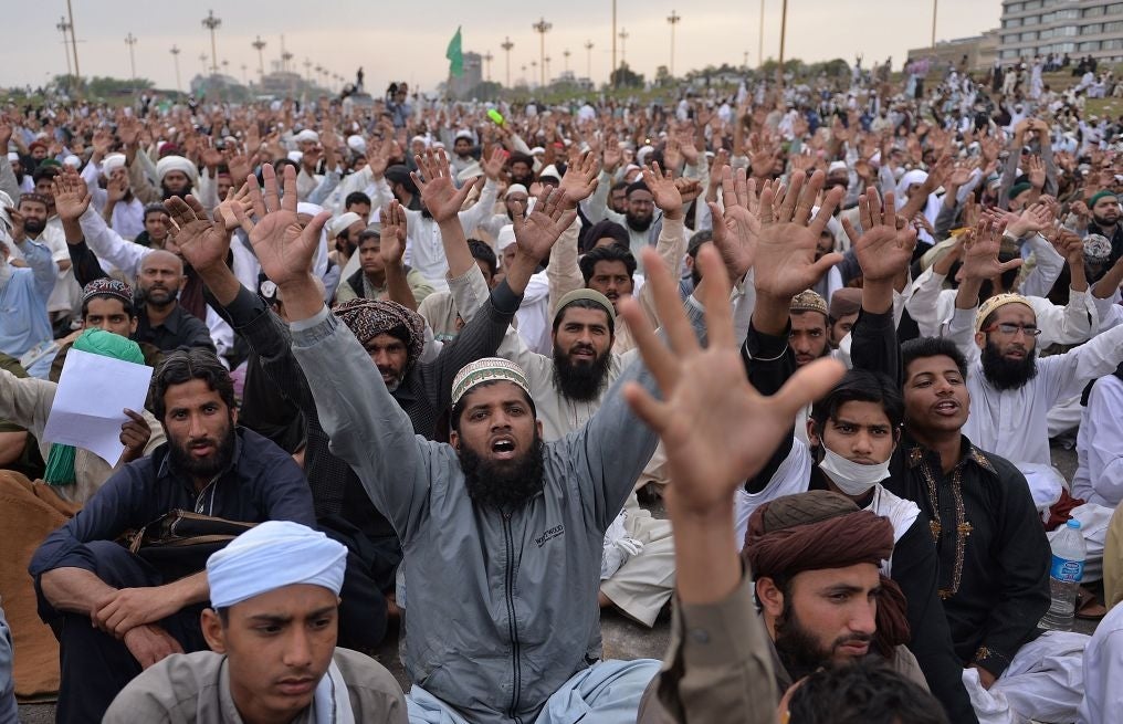 Supporters of executed Islamist Mumtaz Qadri shout slogans as they sit-in during an anti-government protest in front of the parliament building in Islamabad on 28 March, 2016