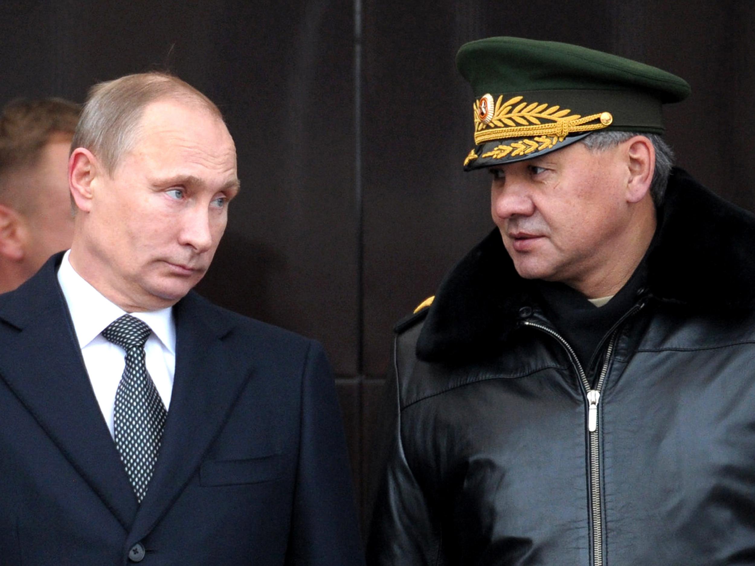 Russia's President Vladimir Putin speaks with Defence Minister Sergei Shoigu