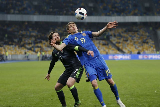 Wales midfielder Joe Allen battles for possession with the Ukraine’s Denis Garmash during the friendly defeat for Chris Coleman’s side