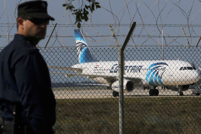 A policeman stands guard at Larnaca Airport near a hijacked Egypt Air A320