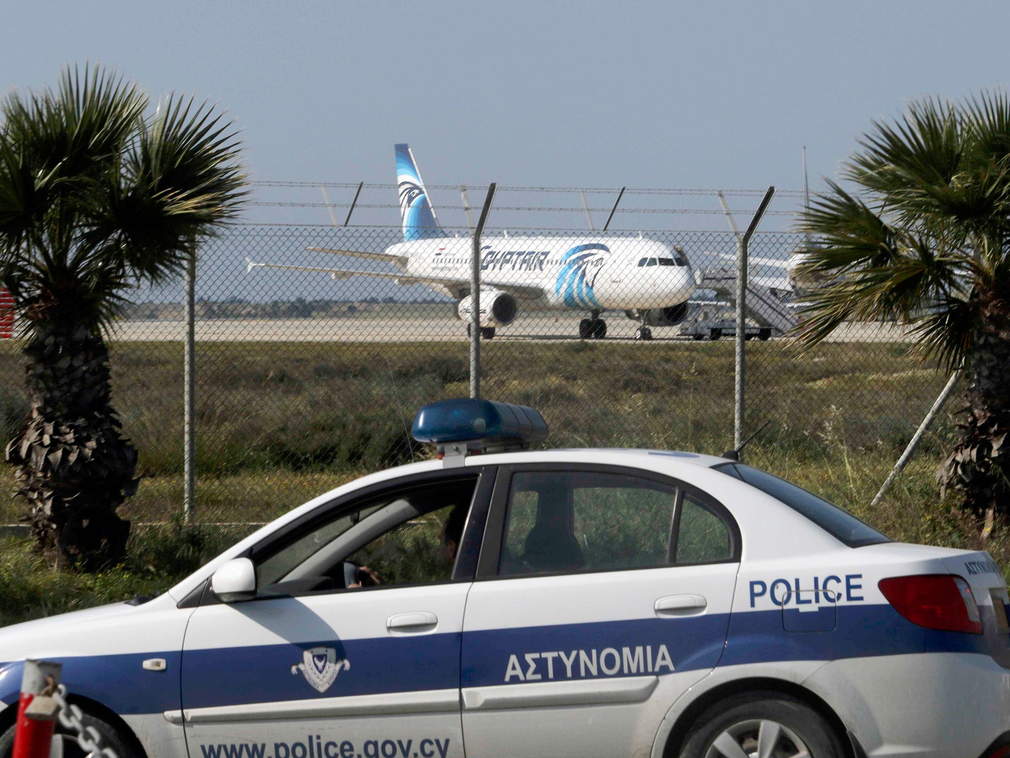 Police stand guard at Larnaca Airport near a hijacked Egyptair Airbus A320
