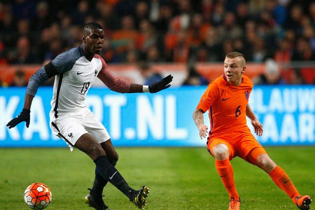 Jordy Clasie in action against Paul Pogba of France