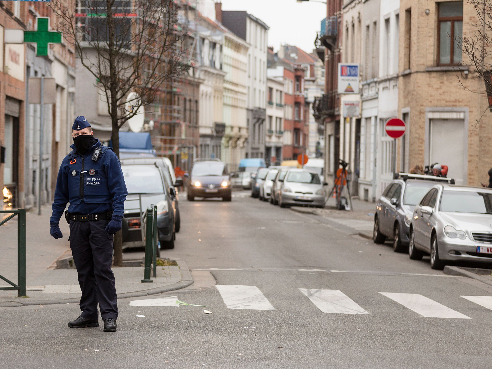 A policeman stands guard on a street in the Brussels district of Molenbeek