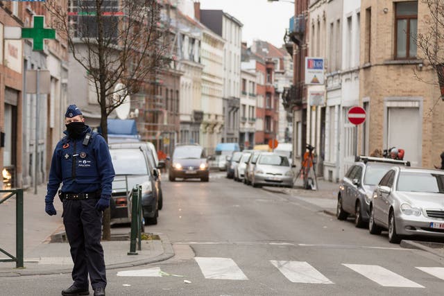 A policeman stands guard on a street in the Brussels district of Molenbeek