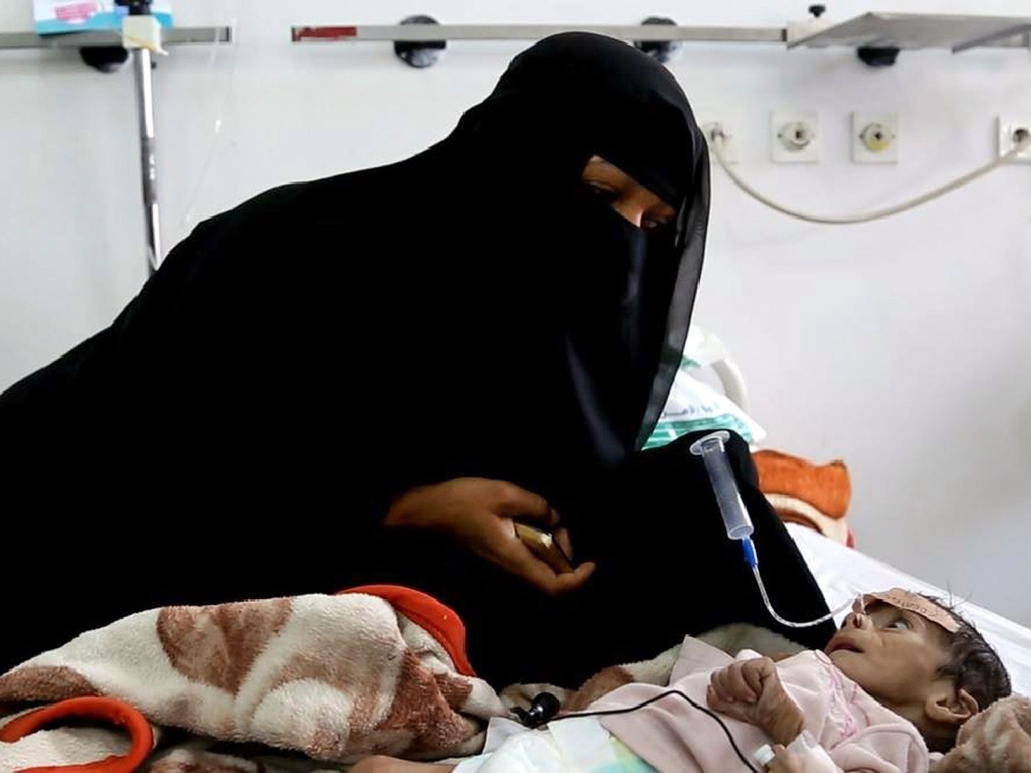 Udai Faisal with his mother Intissar Hezzam at Al-Sabeen Hospital in Sanaa, Yemen.