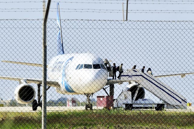 Passengers evacuate a hijacked EgyptAir plane at Larnaca airport on Tuesday