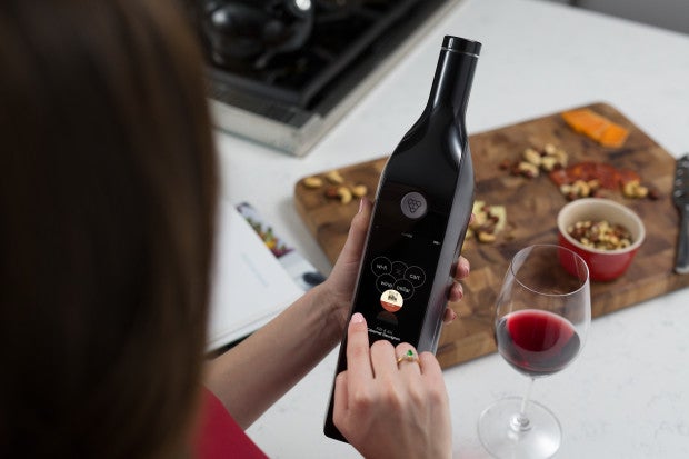 A woman uses the Kuvée to find out more about her wine
