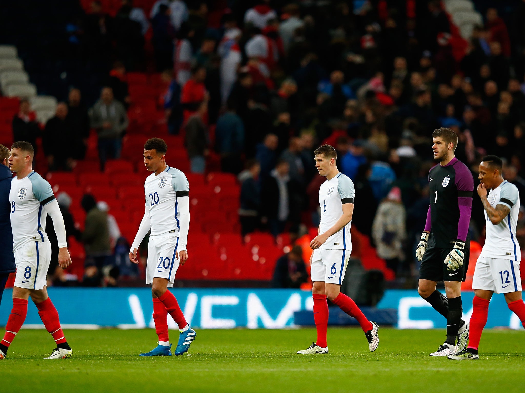 Deflated England players leave the field after losing to the Netherlands