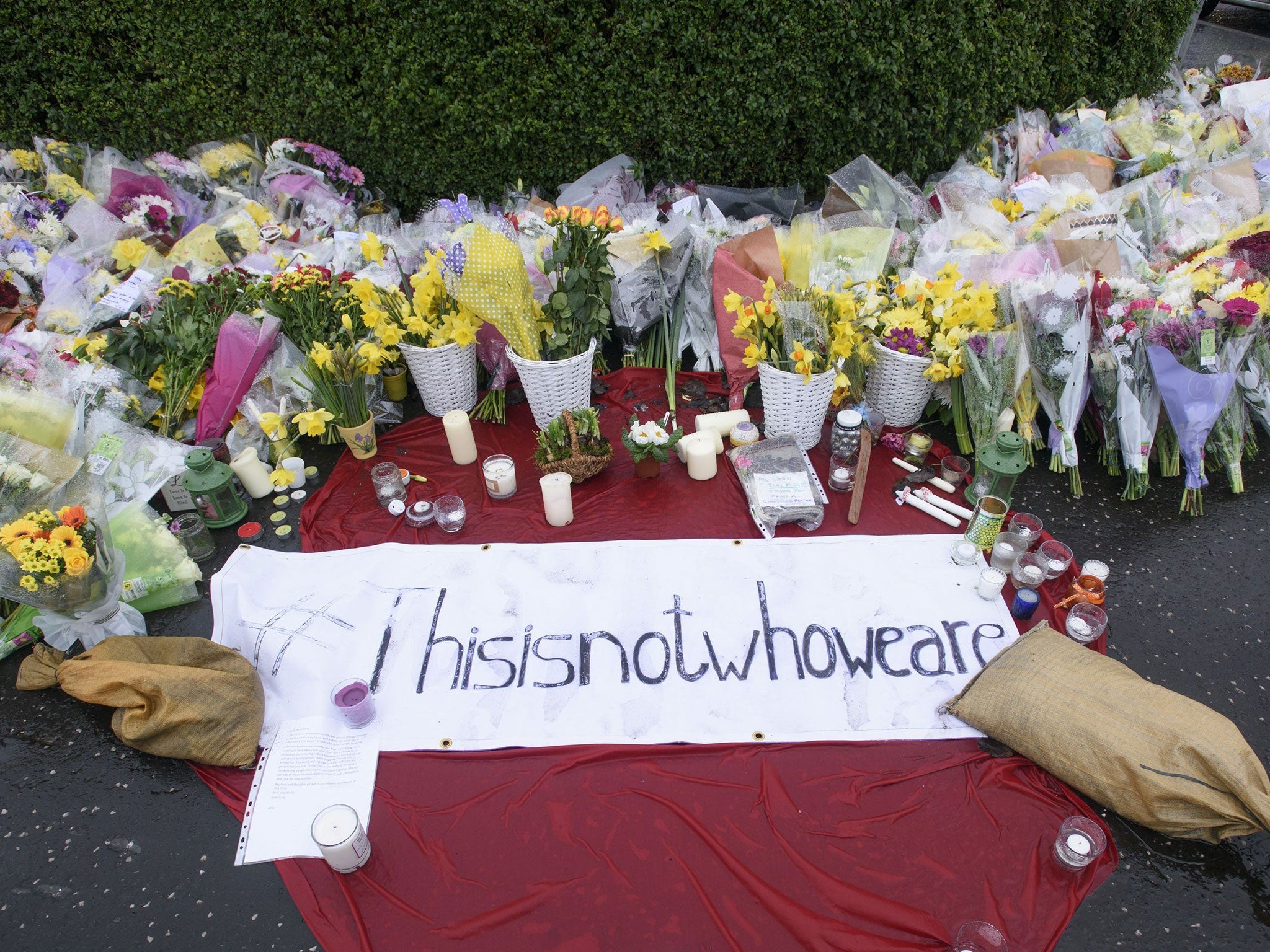 Tributes left to Asad Shah outside his shop in Shawlands, Glasgow