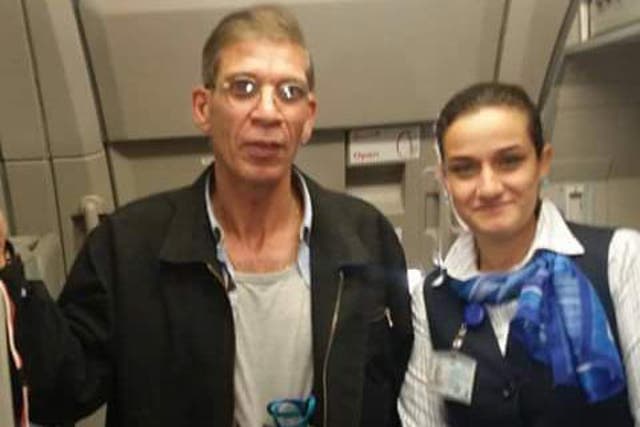 The air stewardess can be seen posing next to 59-year-old Seif Eldin Mustafa