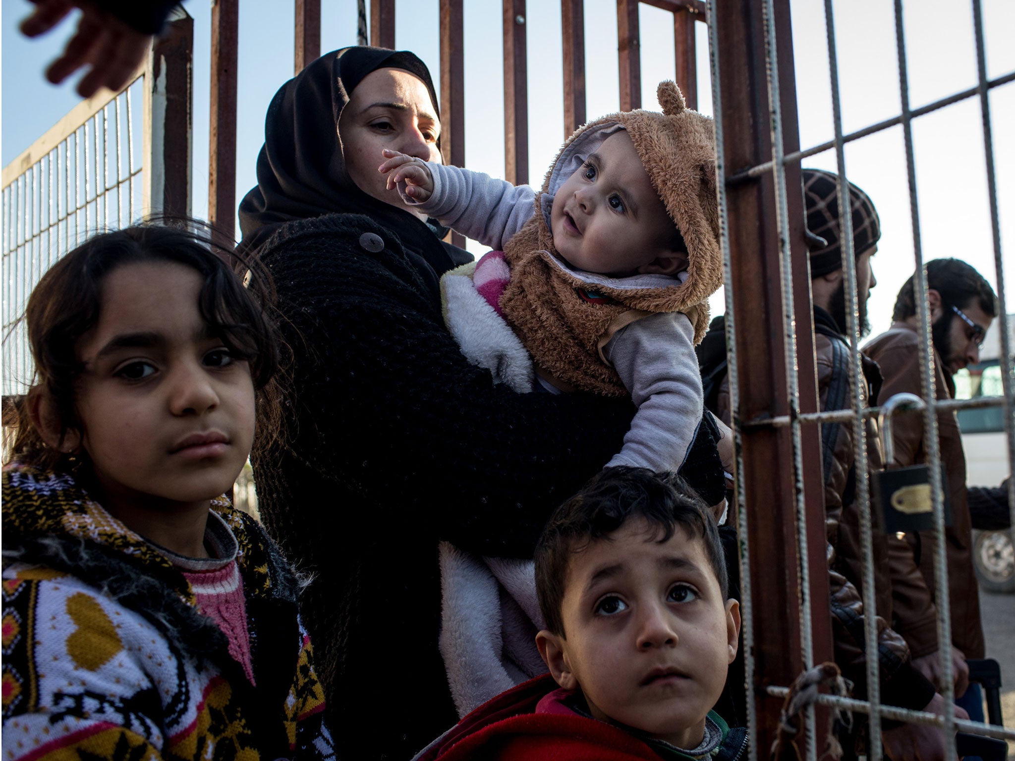 Migrants wait at the Syria-Turkey border