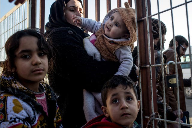 Migrants wait at the Syria-Turkey border