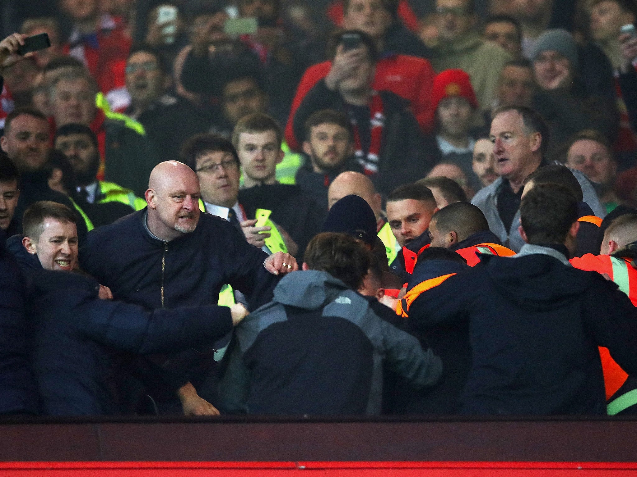 Fans had to be restrained during the second leg between Manchester United and Liverpool