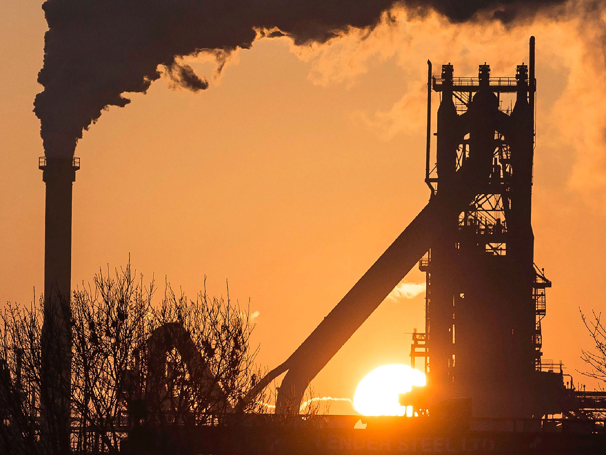 The sun rises above Tata Steel's Scunthorpe Plant in north east England