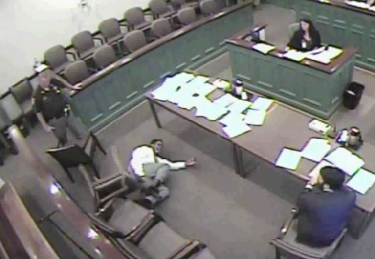 Mr King, 27, screams three times and falls to the floor while the judge calmly shuffles papers