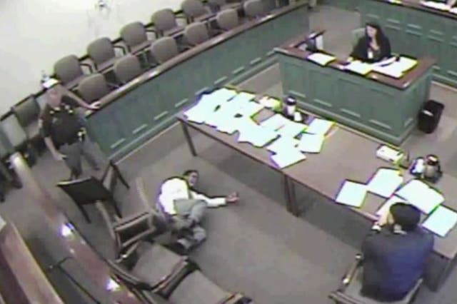 Mr King, 27, screams three times and falls to the floor while the judge calmly shuffles papers