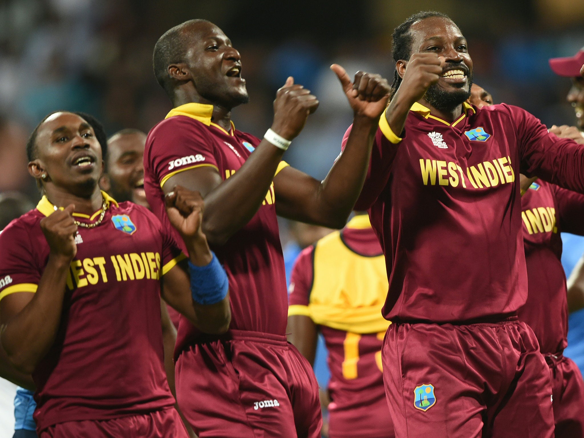 West Indies's captain Darren Sammy, Dwayne Bravo and Chris Gayle celebrate victory in the World T20 semi-final