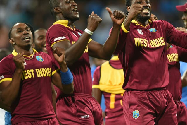 West Indies's captain Darren Sammy, Dwayne Bravo and Chris Gayle celebrate victory in the World T20 semi-final