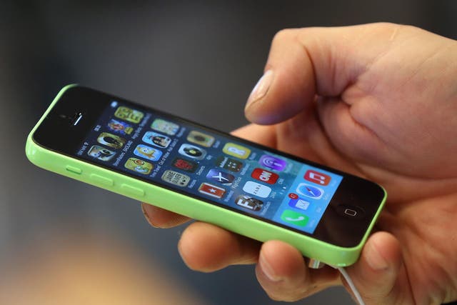 A man uses an iPhone 5C at the Berlin Apple Store