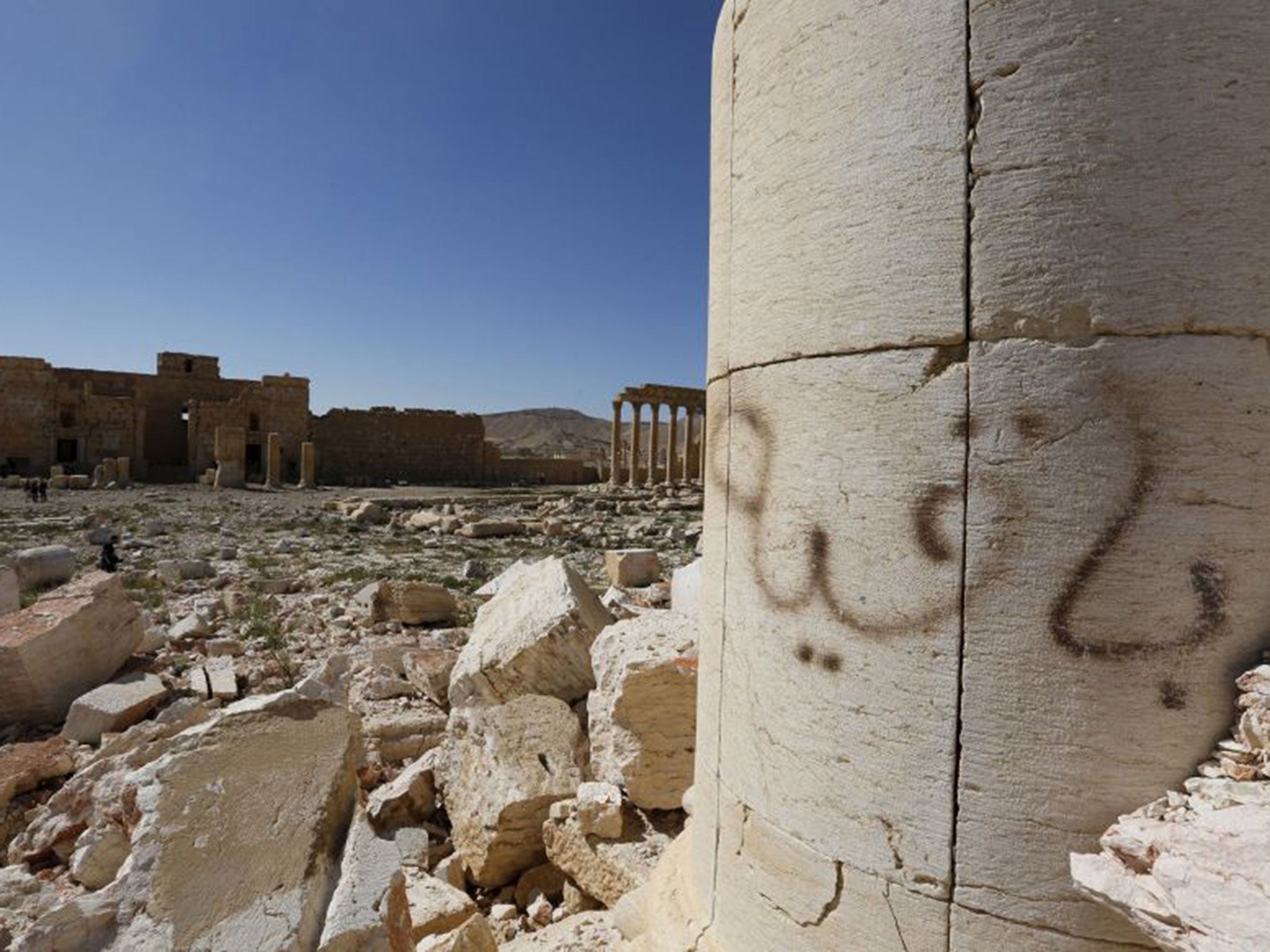 Graffiti sprayed by Islamic State militants which reads "We remain" is seen at theTemple of Bel in historic city of Palmyra.