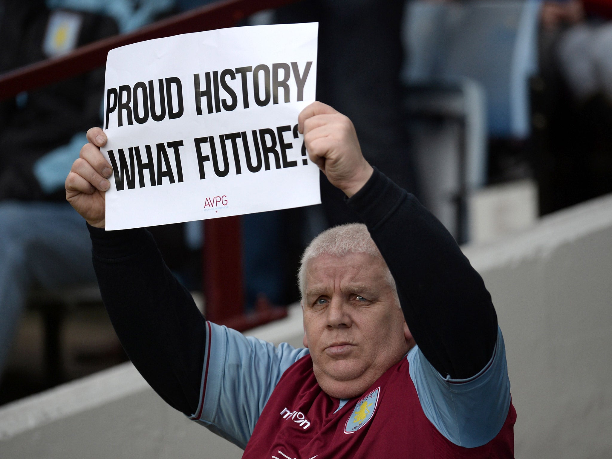 An Aston Villa fan protests ahead of the match with Chelsea