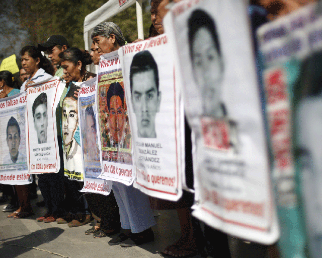 Relatives of the missing students from Ayotzinapa College Raul Isidro Burgos take part in a demonstration