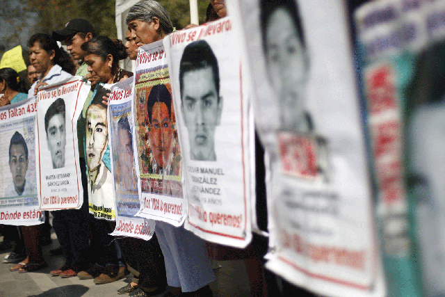 Relatives of the missing students from Ayotzinapa College Raul Isidro Burgos take part in a demonstration