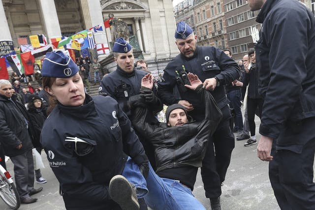 Belgian police arrest protesters at Place de la Bourse at a conter-protest to a planned far-right rally in Brussels, Belgium, 2 April 2016.