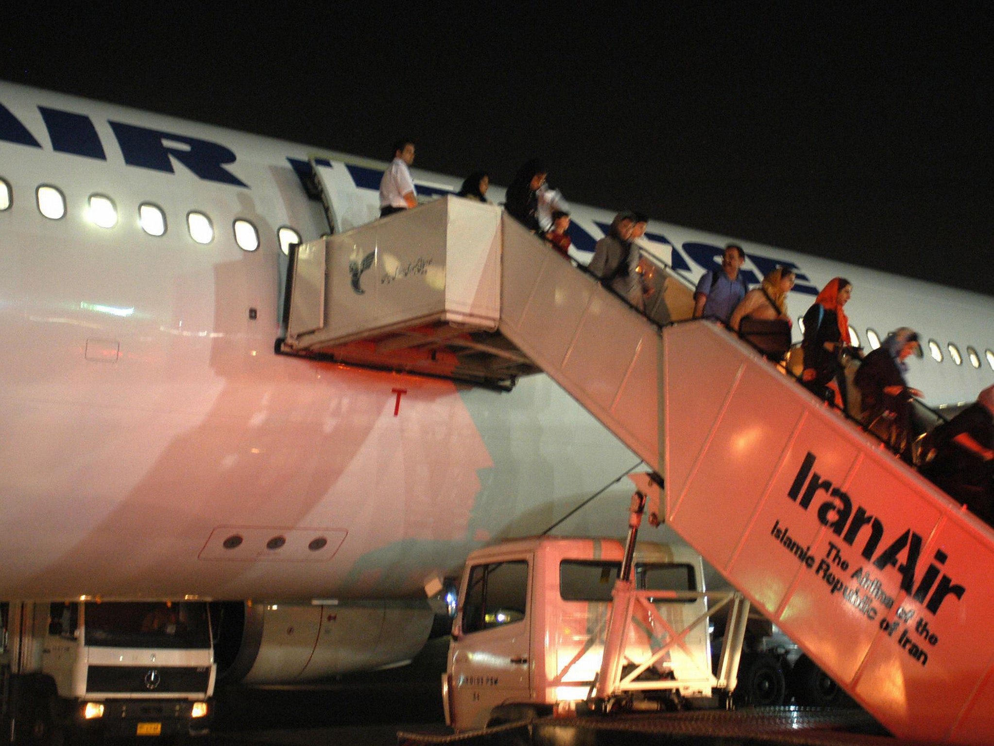 Passengers of Paris-Tehran flight of Air France take the stairs down to Tehran's Mehrabad airport in June 2004