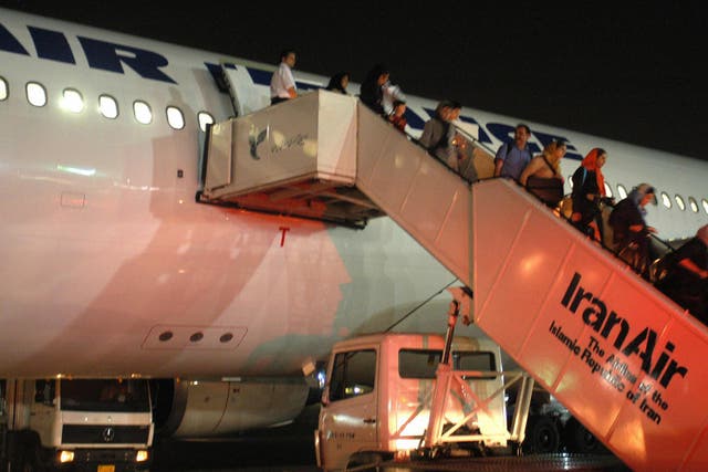Passengers of Paris-Tehran flight of Air France take the stairs down to Tehran's Mehrabad airport in June 2004
