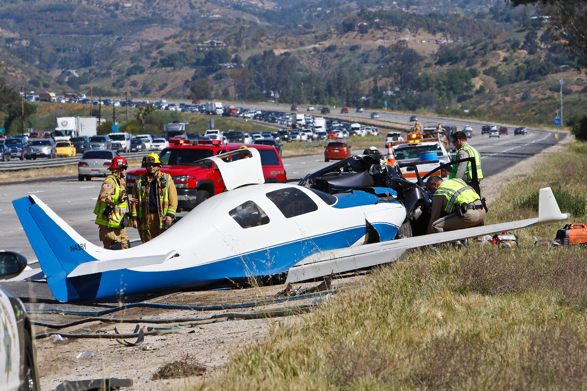 Emergency personnel investigating the scene of plane crash in Fallbrook, California