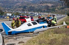 Plane crashes onto San Diego highway killing passenger in parked car