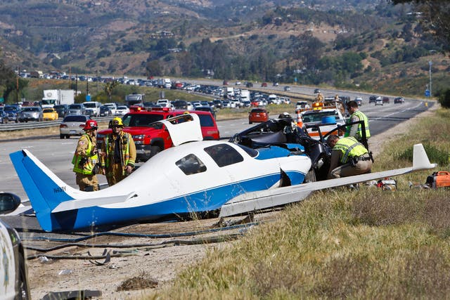 Emergency personnel investigating the scene of plane crash in Fallbrook, California