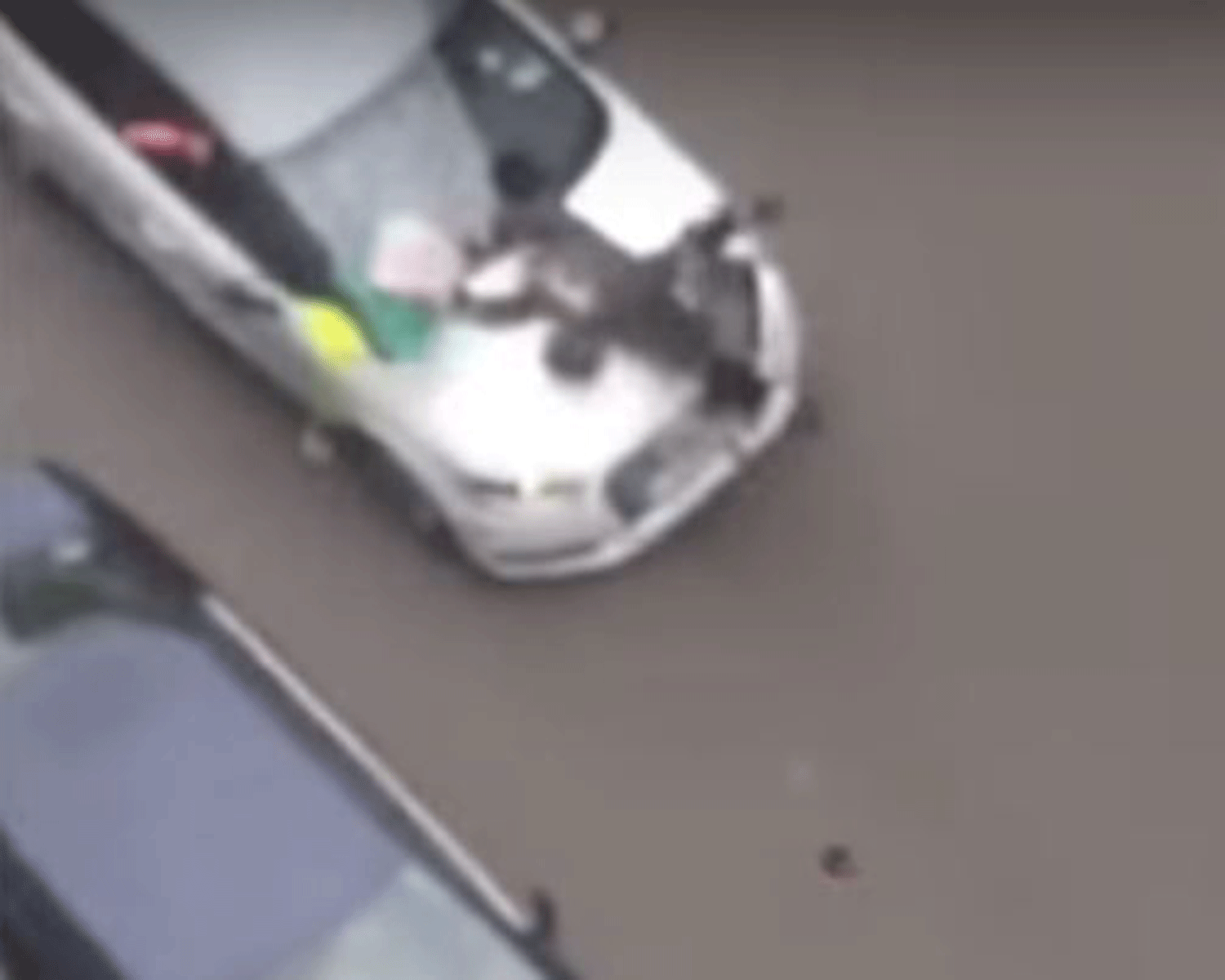 The car does not stop as it ploughs into a Muslim woman crossing the road