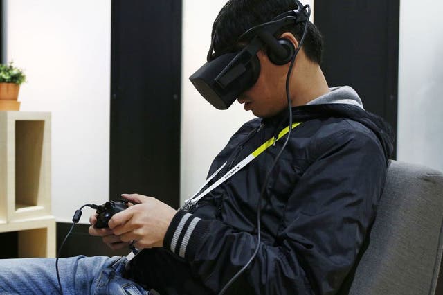 A man uses the Oculus Rift at CES in Las Vegas