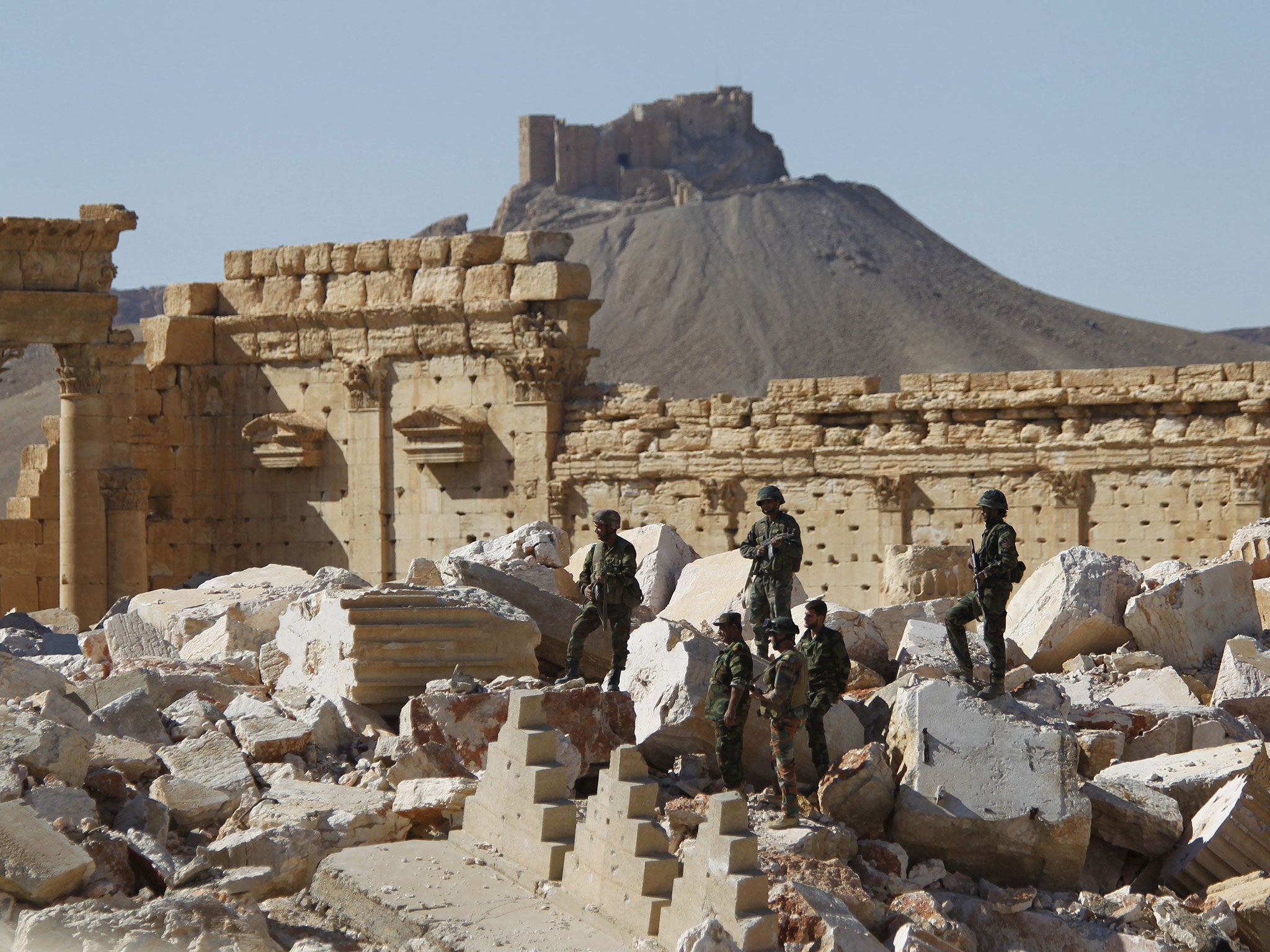 Syrian army soldiers in the ruins of the temple of Bel in Palmyra, which was retaken from Isis