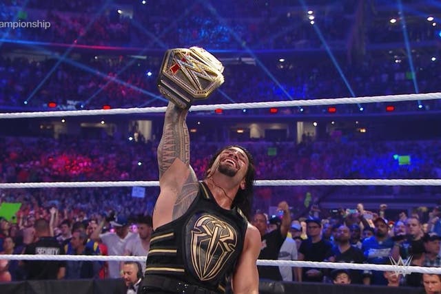 Roman Reigns celebrates his victory at WrestleMania over Triple H