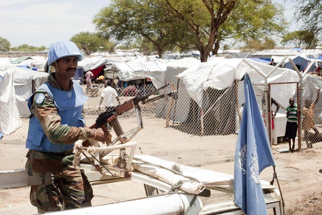 A United Nations peacekeeper keeps guard outside the Bor camp for the internally displaced in Bor town Jonglei state, South Sudan