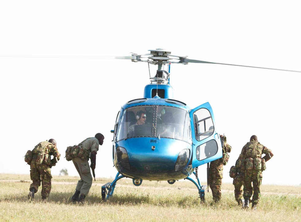 Kenyan rangers prepare to board a helicopter