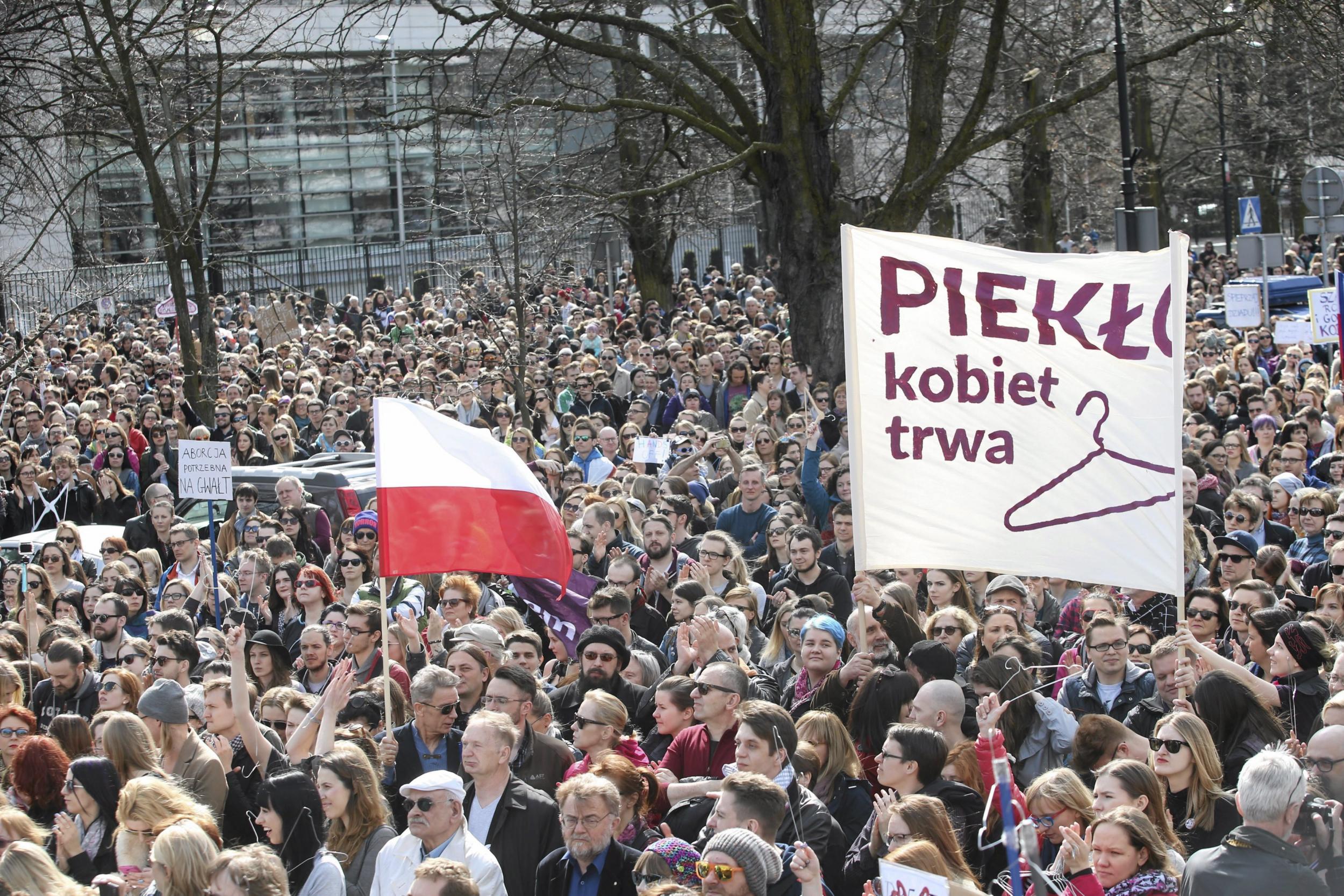 People demonstrate against the Polish government's plan of tightening the abortion law in front of the Parliament in Warsaw, Poland. The banner reads: "Hell of women continues".