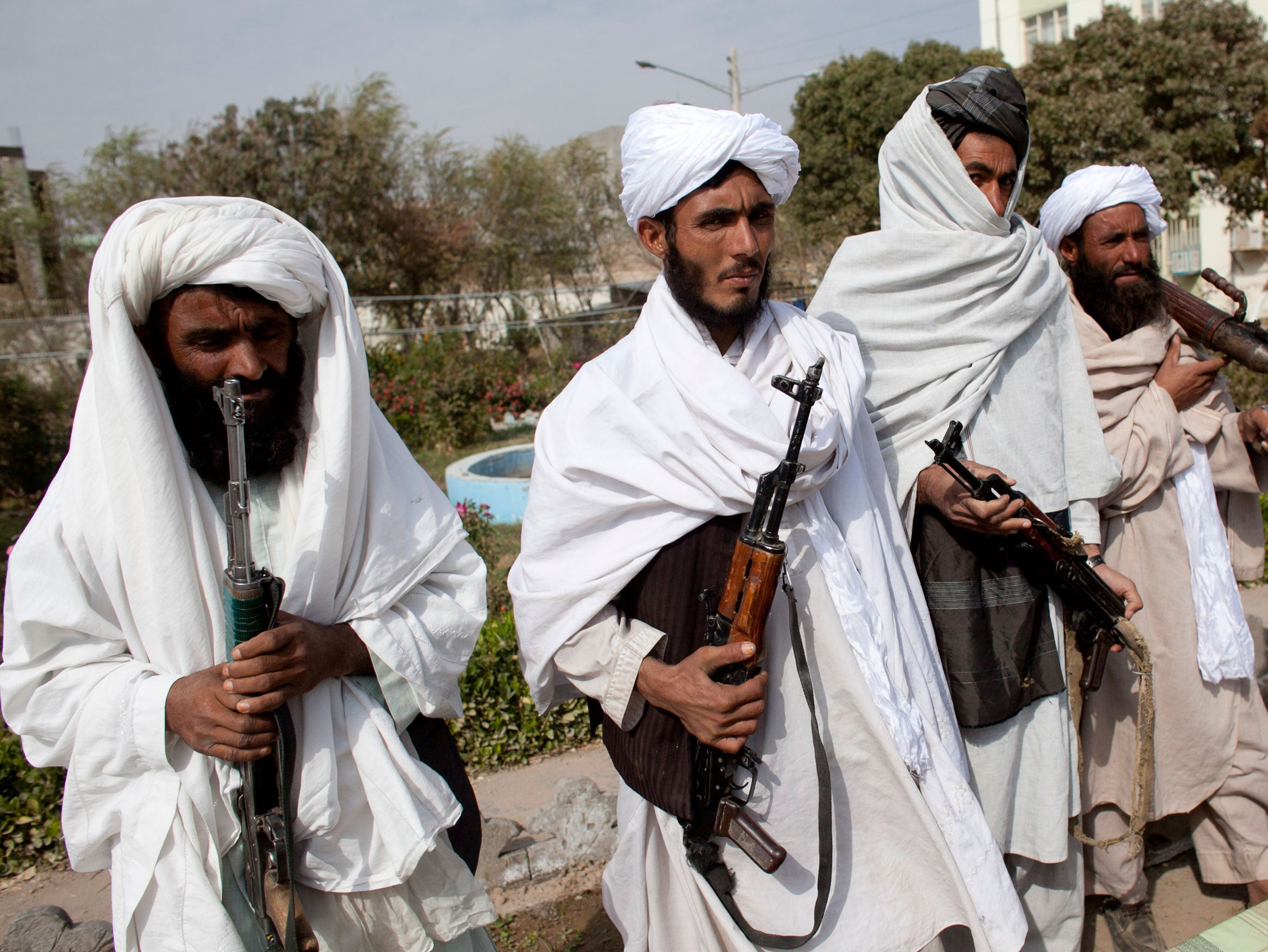 Armed Taliban militants surrender to government forces in Herat, Afghanistan in November 2010